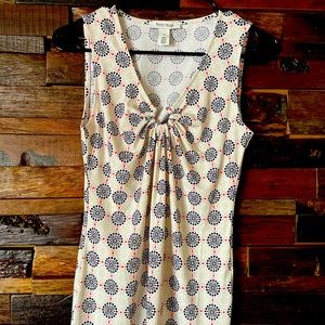 Geometric top with silver clip in center.